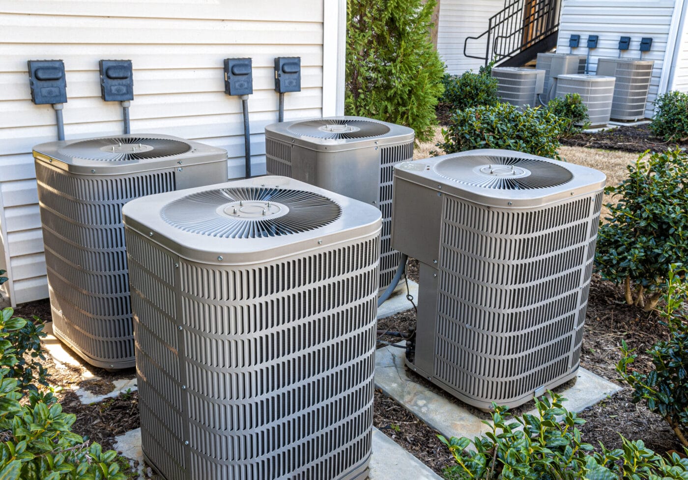 four apartment air conditioners outside.